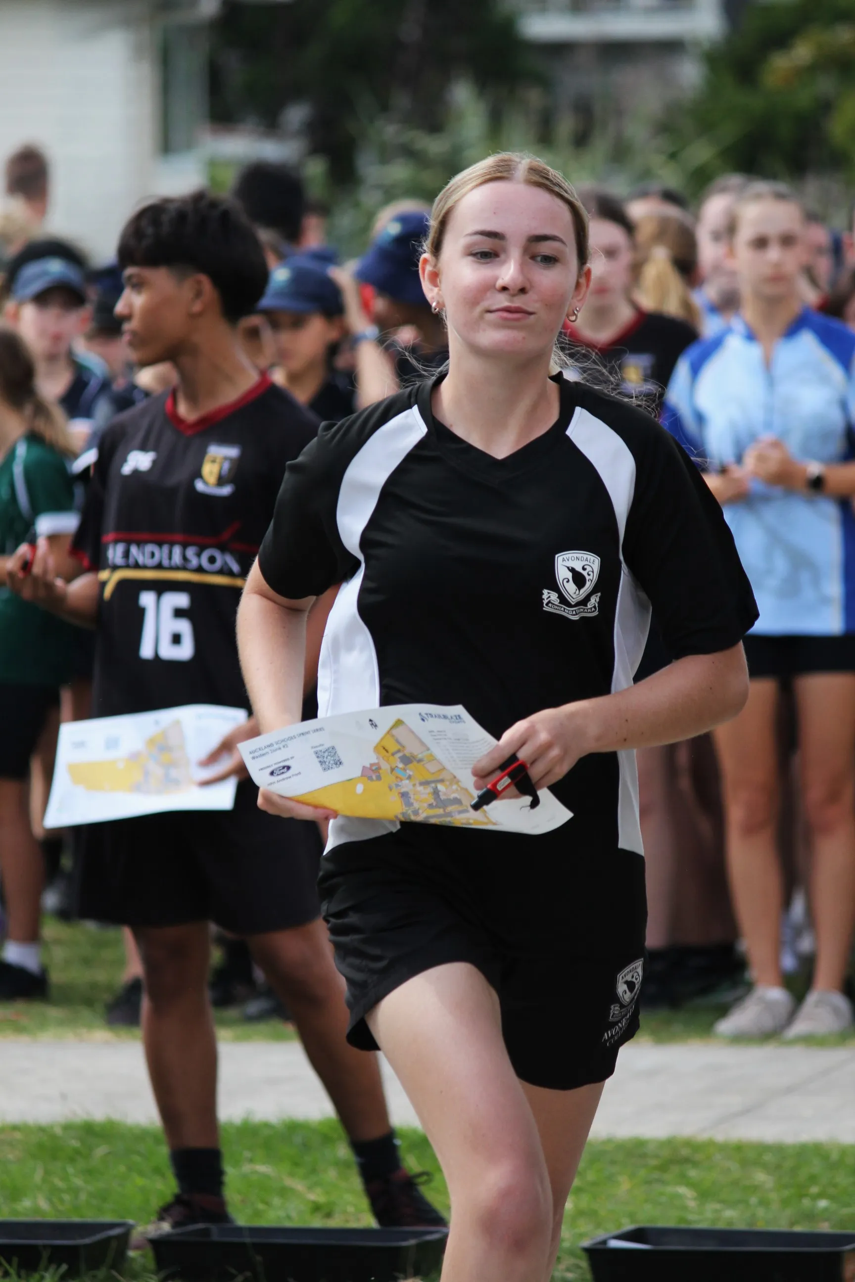 A student sprints with map in hand at a Sprint Series race